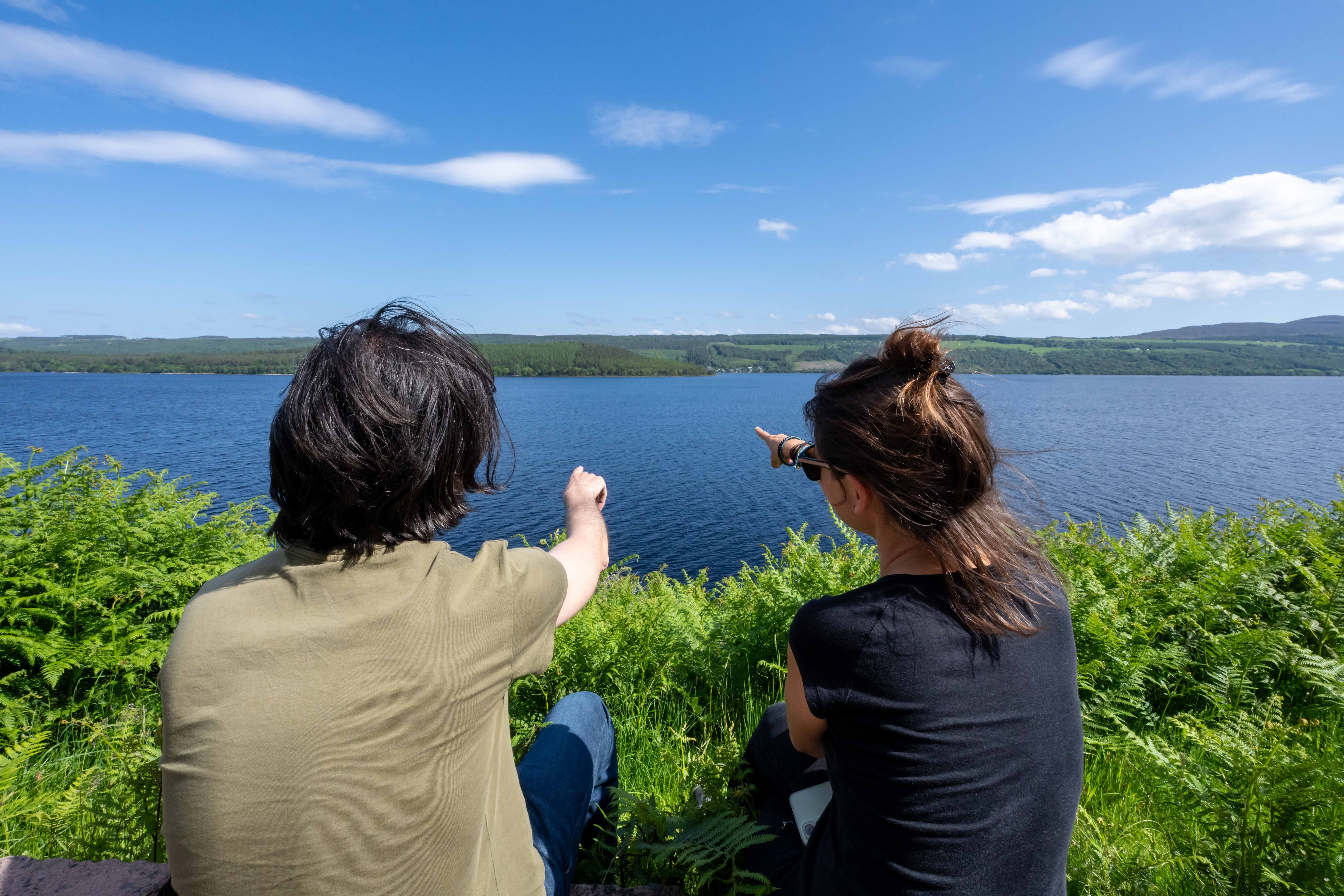 Two young visitors pointing towards the mysterious waters of Loch Ness at the Loch Ness Experience